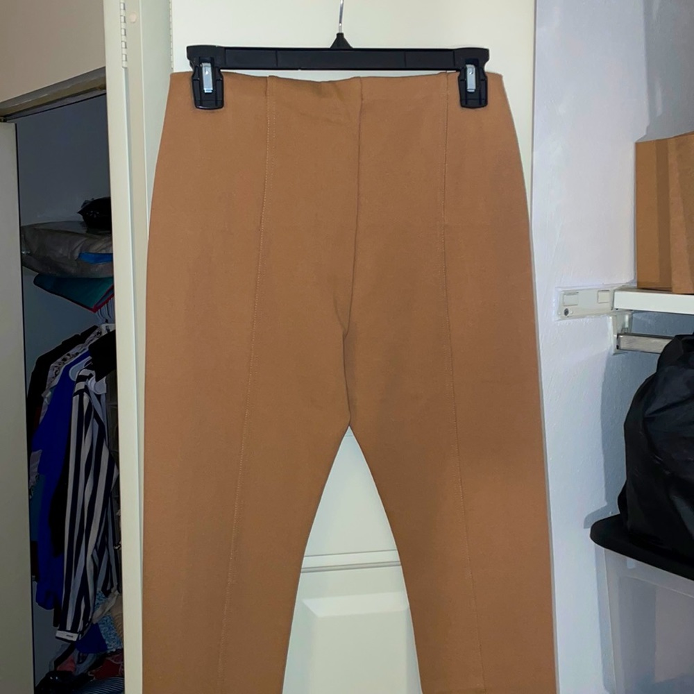 Tan colored dress pants never worn. Comes with tags